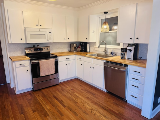 kitchen with stainless steel appliances, pendant lighting, and white cabinetry