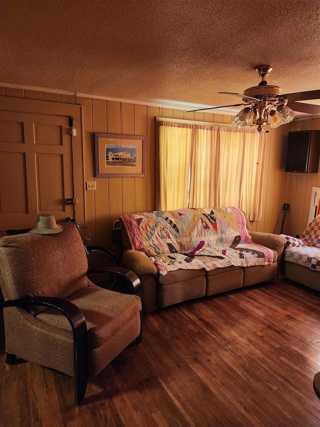 living area featuring dark wood finished floors, a textured ceiling, and ceiling fan