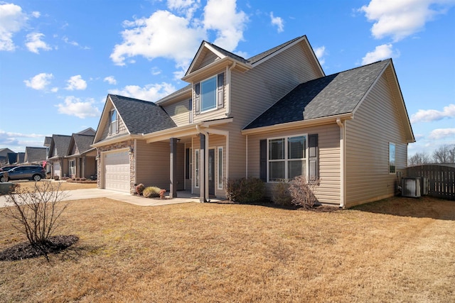 view of front of home featuring driveway, an attached garage, roof with shingles, and a front yard