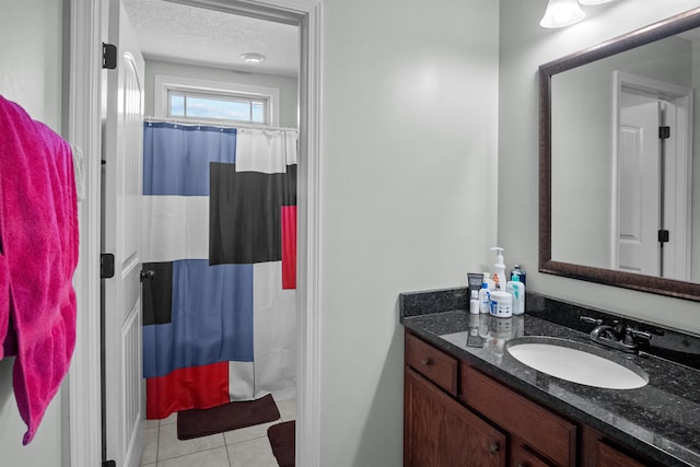 bathroom featuring curtained shower, a textured ceiling, vanity, and tile patterned floors