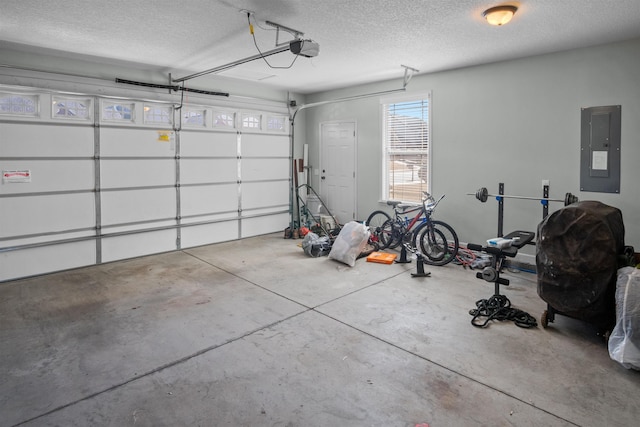 garage featuring electric panel and a garage door opener