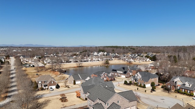 birds eye view of property featuring a water view and a residential view