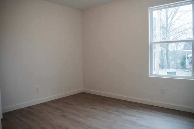 empty room with wood finished floors and baseboards