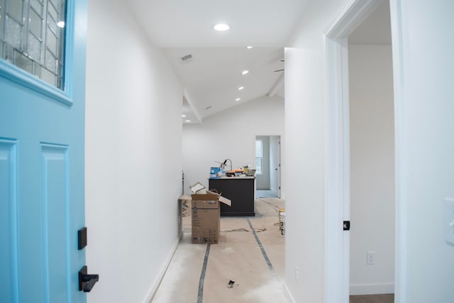 hall featuring high vaulted ceiling, recessed lighting, visible vents, and baseboards