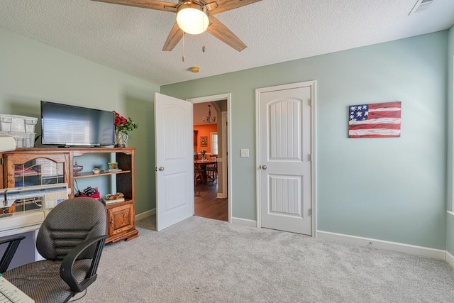 home office with baseboards, light carpet, visible vents, and a textured ceiling