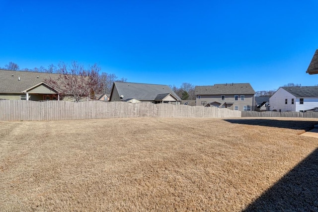 view of yard featuring a residential view and fence