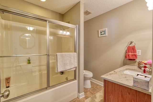 bathroom with shower / bath combination with glass door, visible vents, toilet, vanity, and a textured ceiling