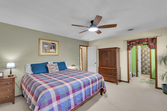 bedroom with light carpet, a ceiling fan, visible vents, and baseboards