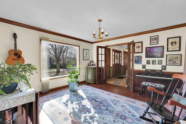 entrance foyer featuring dark wood-style floors, a notable chandelier, ornamental molding, a textured ceiling, and baseboards