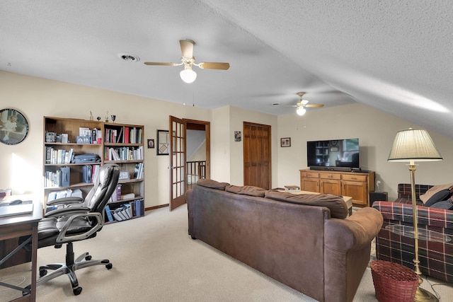 living room with light carpet, baseboards, visible vents, lofted ceiling, and a textured ceiling