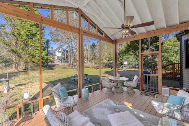 sunroom / solarium with a ceiling fan, lofted ceiling, and a healthy amount of sunlight