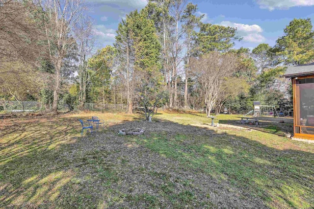 view of yard featuring a playground and fence