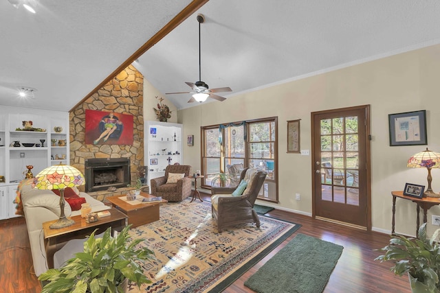 living area featuring a textured ceiling, a stone fireplace, dark wood-type flooring, baseboards, and built in features