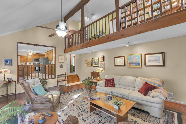 living room featuring baseboards, visible vents, a ceiling fan, wood finished floors, and beamed ceiling