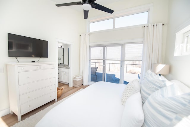 bedroom with ensuite bathroom, access to outside, and light wood-type flooring