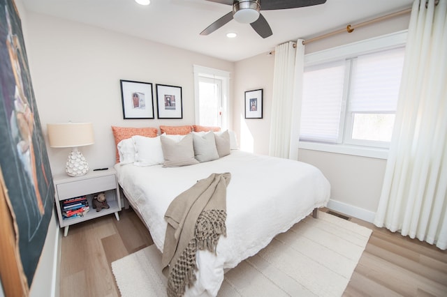 bedroom featuring light wood finished floors, baseboards, visible vents, a ceiling fan, and recessed lighting