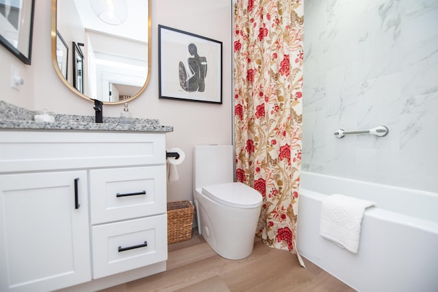 bathroom featuring shower / tub combo with curtain, vanity, toilet, and wood finished floors