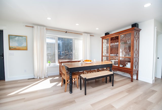 dining area with light wood-type flooring, baseboards, and recessed lighting