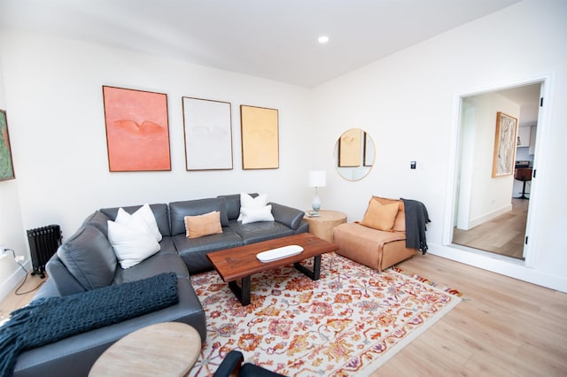 living room featuring baseboards, wood finished floors, and recessed lighting