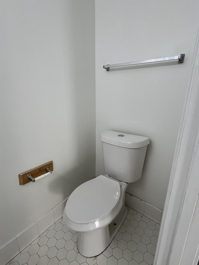 bathroom featuring toilet and baseboards