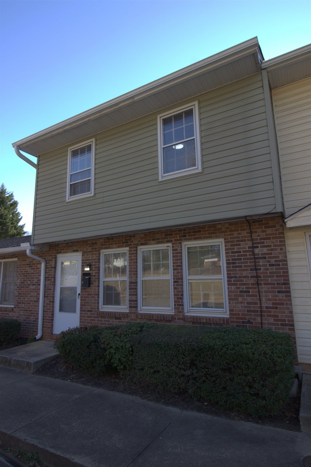 townhome / multi-family property featuring brick siding