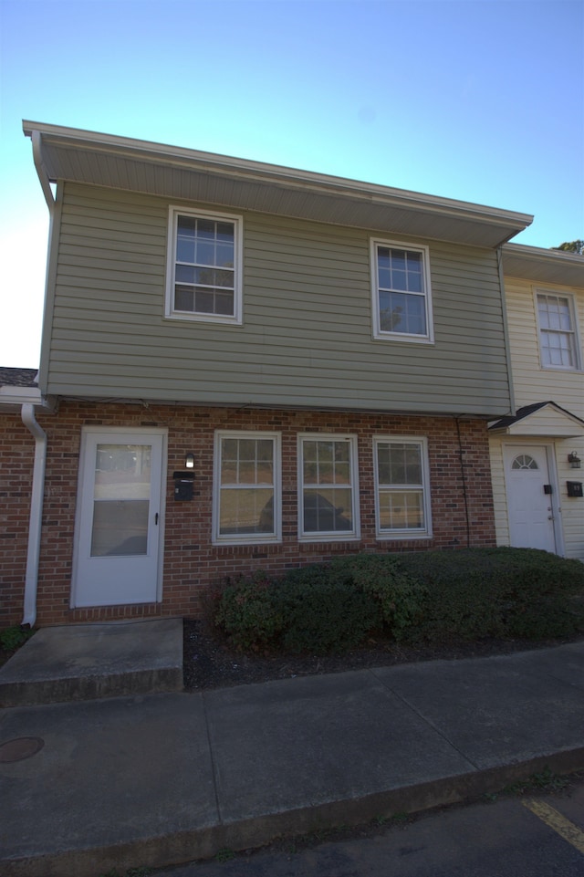 view of property with brick siding