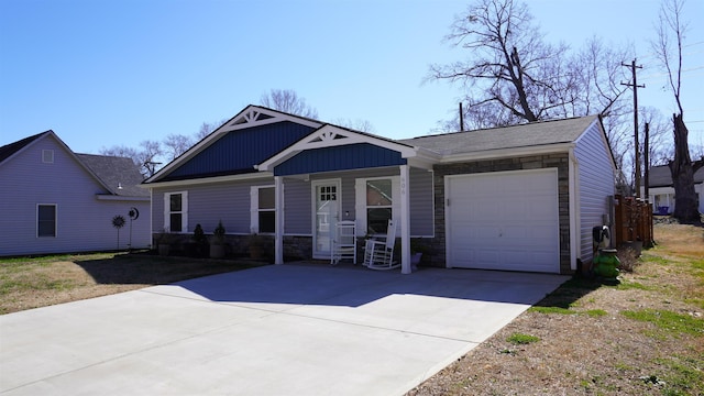 view of front of property featuring stone siding, board and batten siding, an attached garage, and driveway