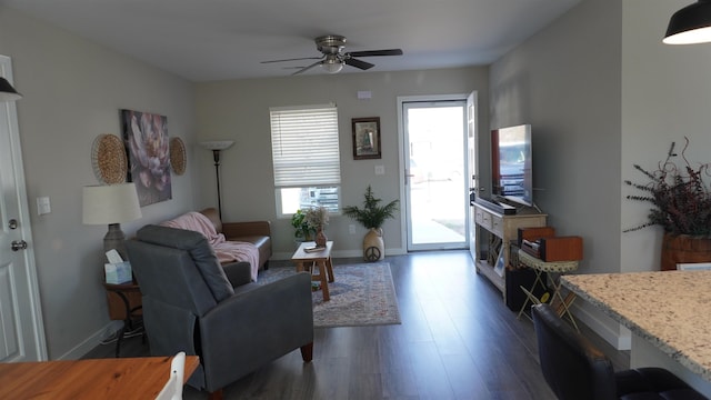 living room featuring ceiling fan, dark wood finished floors, a wealth of natural light, and baseboards