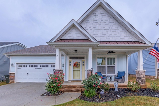 craftsman-style house featuring metal roof, a porch, a garage, concrete driveway, and a standing seam roof