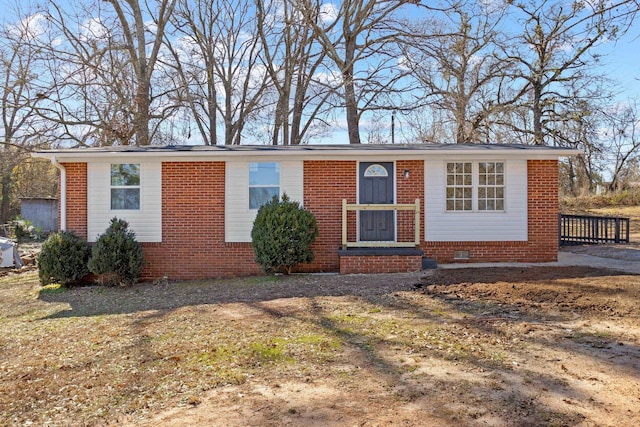 single story home featuring crawl space, a front lawn, and brick siding