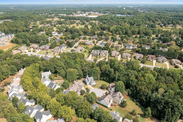 birds eye view of property featuring a forest view and a residential view