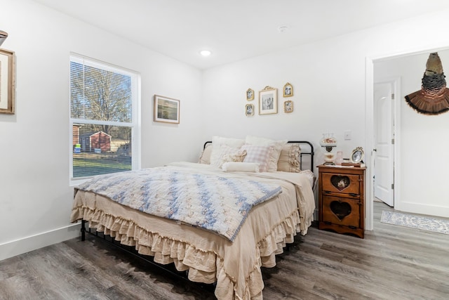 bedroom featuring recessed lighting, dark wood finished floors, and baseboards