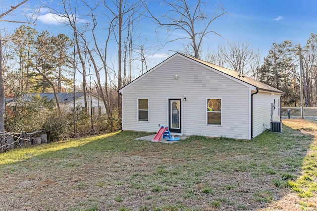 rear view of property with a yard