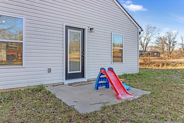 property entrance featuring a patio and a yard