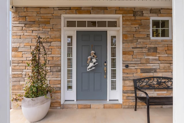 view of exterior entry featuring stone siding