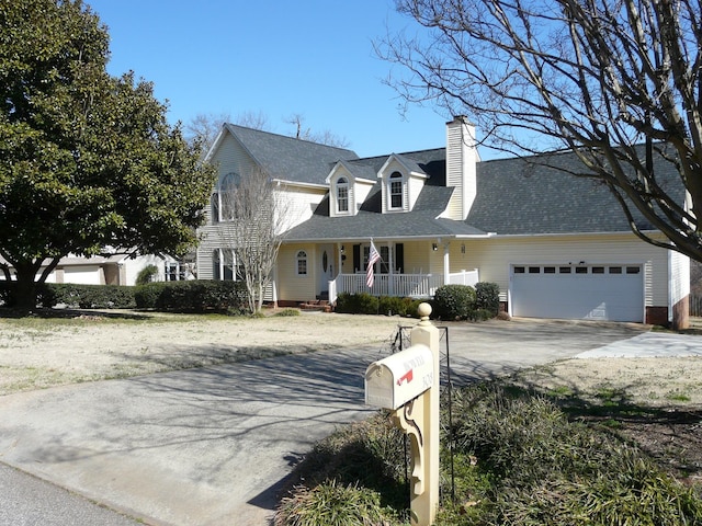 cape cod home featuring a porch, a garage, a shingled roof, concrete driveway, and a chimney