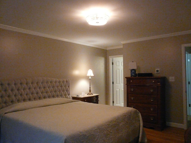 bedroom with ornamental molding, dark wood-style flooring, and baseboards