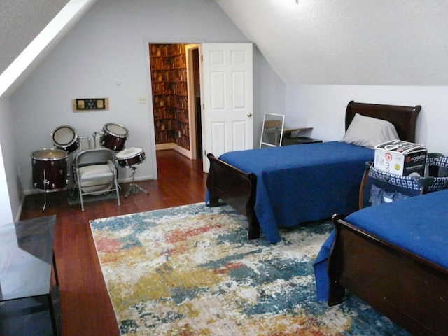 bedroom featuring dark wood-style floors and vaulted ceiling