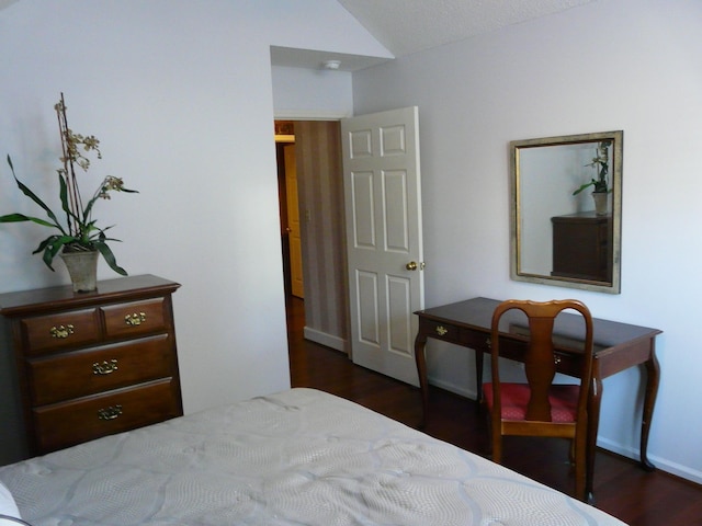 bedroom with lofted ceiling and dark wood-type flooring