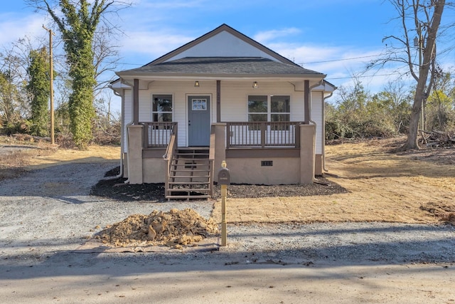 bungalow-style home with crawl space, covered porch, stairs, and roof with shingles