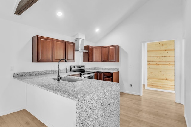 kitchen with wall chimney range hood, light wood-style flooring, stainless steel electric range, and a sink