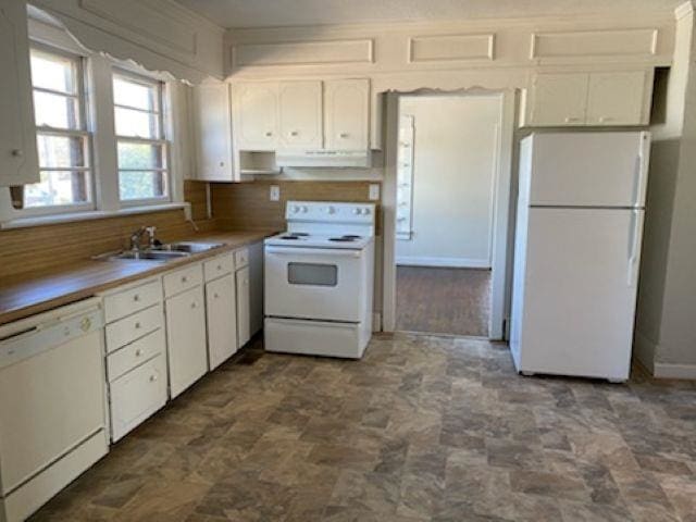 kitchen featuring under cabinet range hood, white appliances, a sink, white cabinets, and light countertops