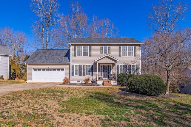 colonial-style house with driveway, an attached garage, and a front lawn