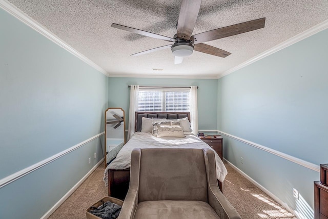 carpeted bedroom with baseboards, a textured ceiling, ornamental molding, and a ceiling fan