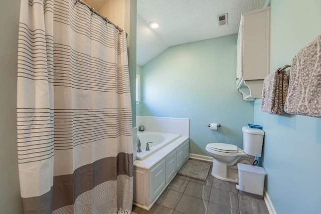 full bathroom featuring a textured ceiling, lofted ceiling, a garden tub, visible vents, and tile patterned floors