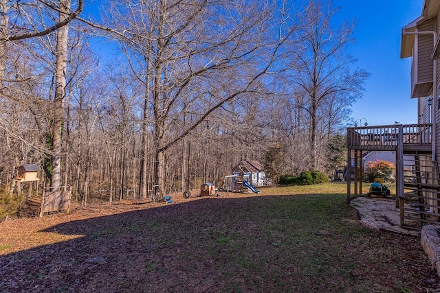 view of yard with stairway, a playground, and a wooden deck