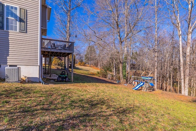 view of yard featuring stairway, a playground, a deck, and central AC unit