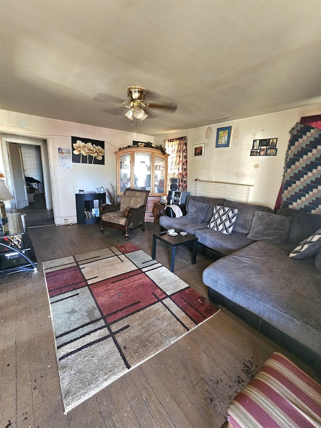 living room with dark wood-style floors and a ceiling fan