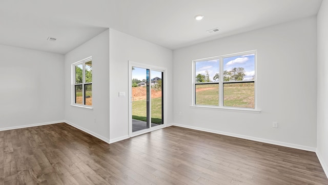 unfurnished room featuring dark wood-style floors and baseboards
