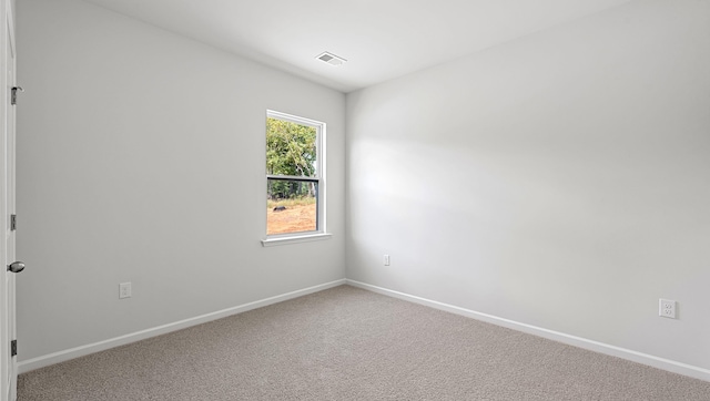 carpeted spare room with baseboards